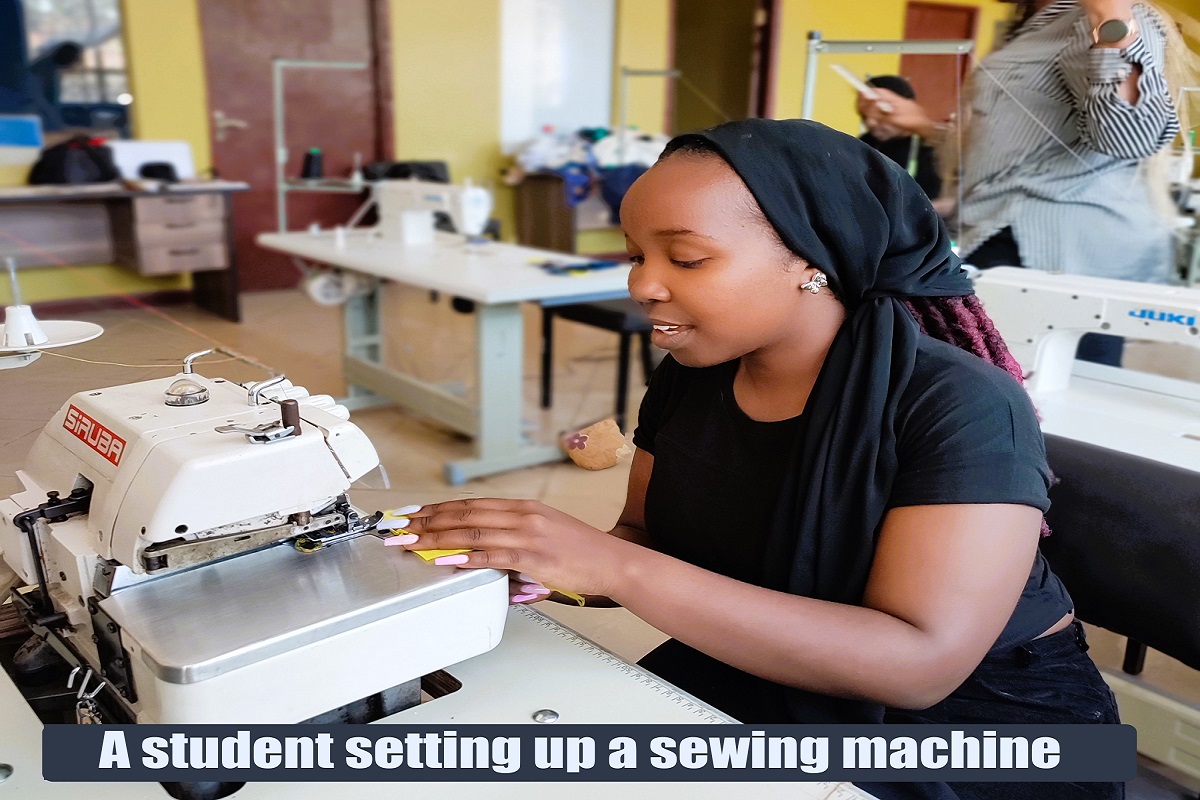 Ivy- A fashion student  designer working on a button hole machine at the Hub 